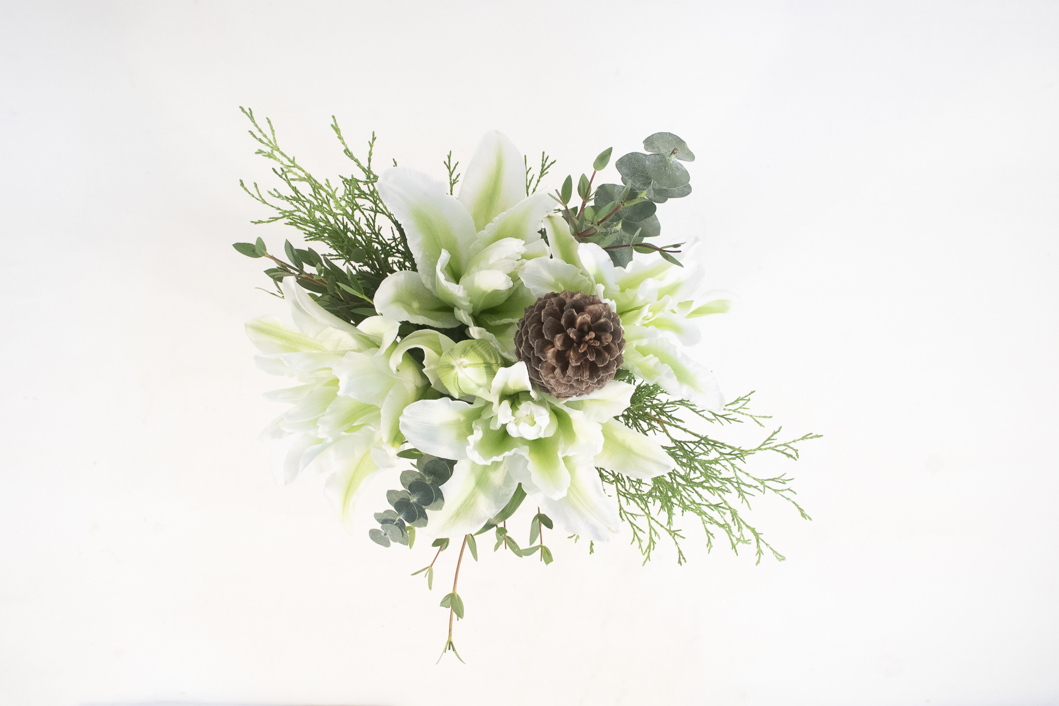 Frosted Pine, winter seasonal bouquet, pine cones, white lilies, eucalyptus